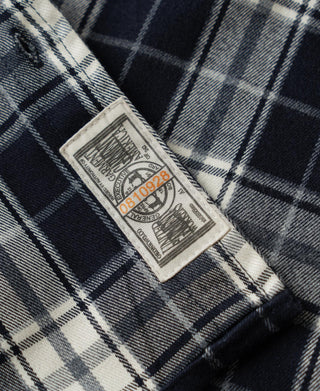 Blue check work shirt inner neck label stitched into the collar area