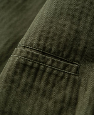 Olive herringbone blazer front pocket and midline seam detail