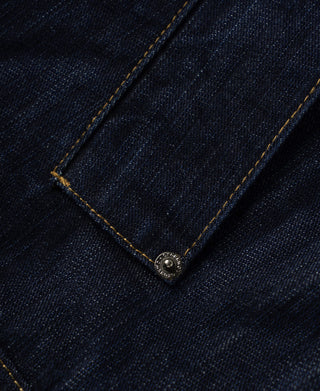 Indigo denim flap pocket with metal button at center