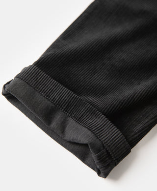 Black corduroy trouser cuff hem with folded edge stitching