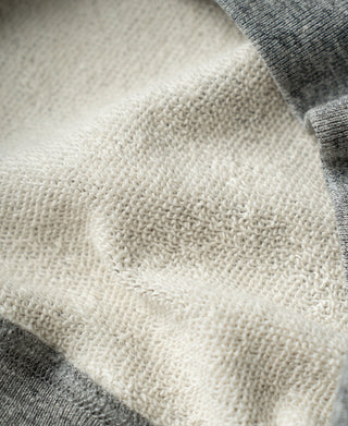 Cream knit V-gusset lining visible at the sweatshirt underarm