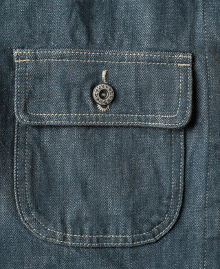 Blue denim barn jacket flap pocket with round metal snap and contrast stitching