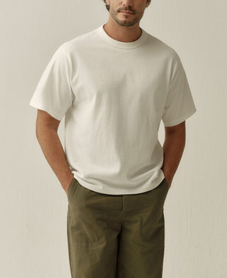 White boxy T-shirt with short sleeves and a crew neck, shown from the front.