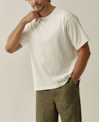 White heavyweight cotton jersey T-shirt with a boxy fit, shown from an angled front view.