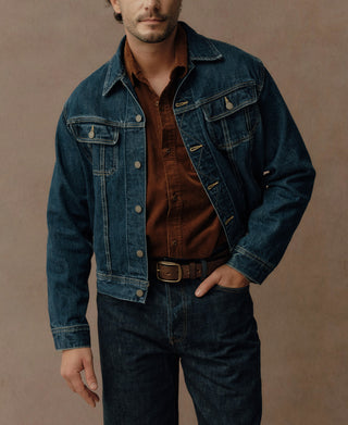 Indigo denim jacket shown open, with pointed collar and buttoned chest pockets