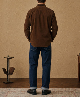 Brown corduroy button-up shirt on model, back view