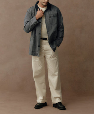 Gray-blue field jacket worn with the front open, showing its chest and lower pockets