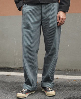 Blue-and-white striped work trousers on model, relaxed straight fit
