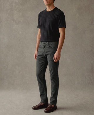 Men's vintage black ribbed cotton T-shirt worn with dark jeans, short sleeves