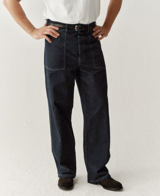 Indigo buckle-back fatigue pants on model, relaxed straight legs with cargo pockets