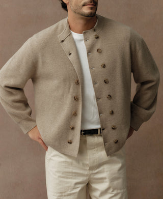 Ecru double-breasted knit cardigan with button-front closure and patch pockets