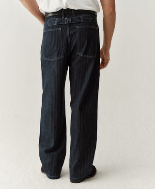 Indigo buckle-back fatigue pants on model, full-length straight leg profile