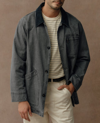 Gray-blue field jacket worn open, with button front and large lower patch pocket