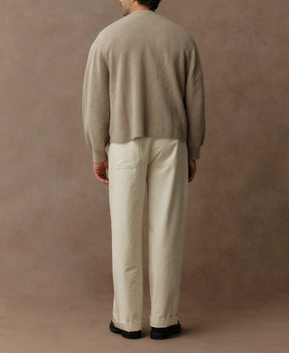 Ecru knit cardigan shown from back with ribbed hem and cuffs